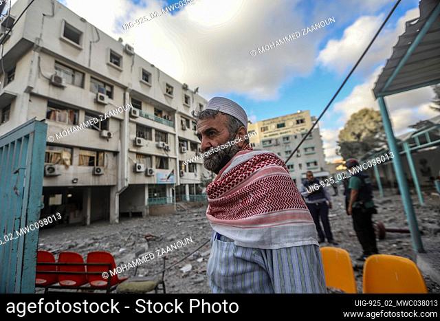 A man looks on sadly at the the damage to the Palestinian Ministry of Health building and Al-Rimal dispensary, as a result of an Israeli airstrike on a target...
