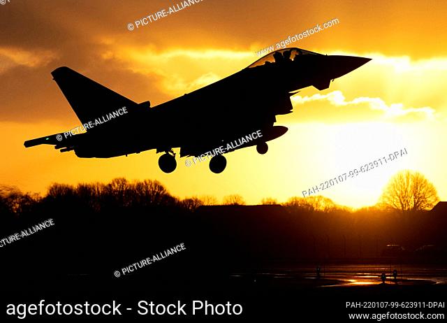 06 January 2022, Lower Saxony, Wittmund: An Luftwaffe Eurofighter Typhoon fighter takes off in front of the rising sun at Wittmundhafen Air Base