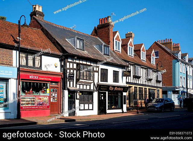 EAST GRINSTEAD, WEST SUSSEX, UK - MARCH 1: View of shops in the High Street in East Grinstead on March 1, 2021. Two unidentified people