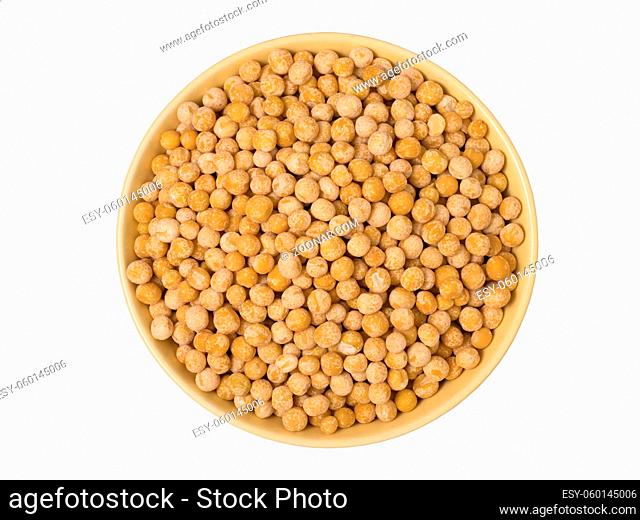 Bowl of yellow dried chickpeas on white background