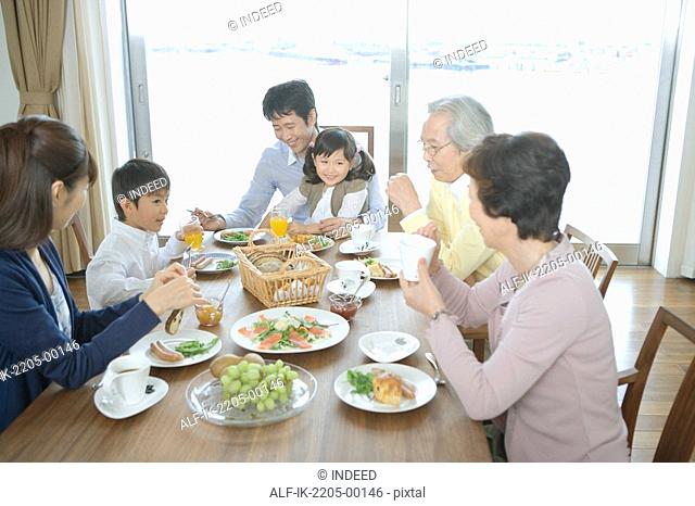 Asian family having breakfast together