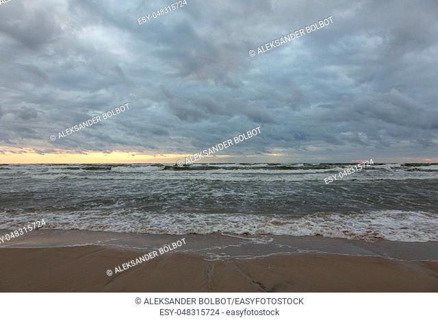 Baltic Sea beach with cloudy sky in summer sunset with before storm, Palanga, Lithuania, Europe