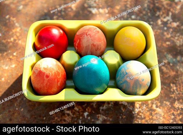 Italy, Turin, Colorful Eater eggs in egg carton