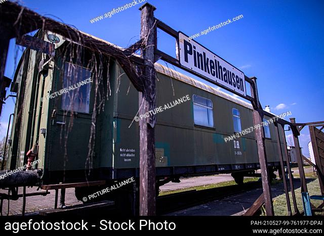 28 April 2021, Mecklenburg-Western Pomerania, Pasewalk: The sign ""Pinkelhausen"" hangs in front of the toilet wagon in the railway experience centre...