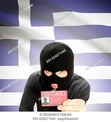 Hacker with flag on background holding ID card in hand - Greece