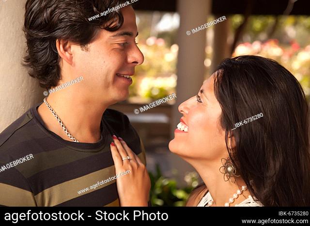 Attractive hispanic couple portrait enjoying each other outdoors