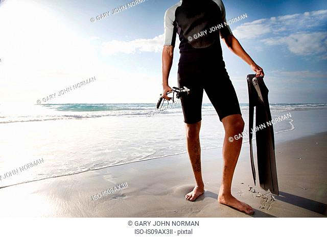 Diver with speargun on beach