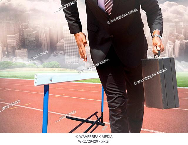 Businessman holding briefcase and running on race track