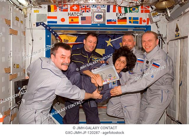 The crewmembers onboard the International Space Station enjoy a light moment as they pose for a group portrait during the ceremony of Changing-of-Command from...