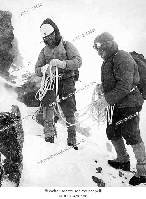 Italian mountaineers Walter Bonatti and Cosimo Zappelli climbing the Grandes Jorasses. Courmayeur, January 1963