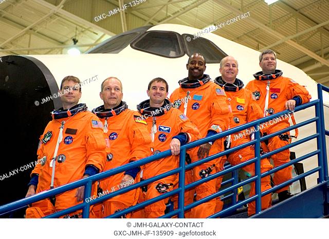 Attired in training versions of their shuttle launch and entry suits, the STS-122 crewmembers take a moment to pose for a photo during a training session in the...