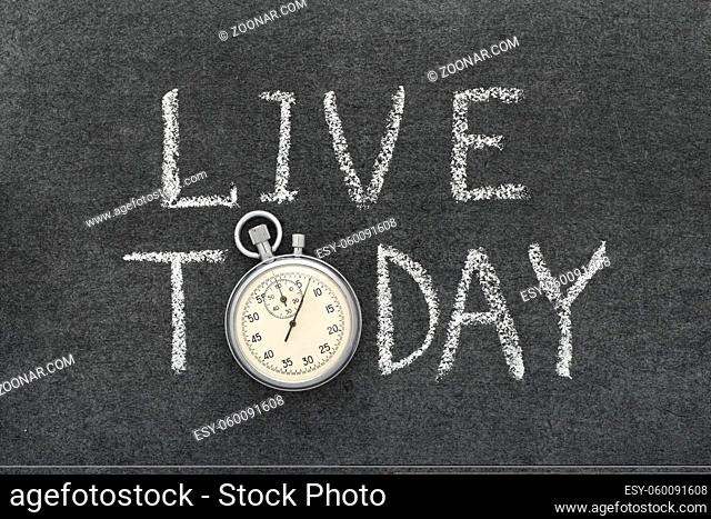 live today concept handwritten on chalkboard with vintage precise stopwatch used instead of O