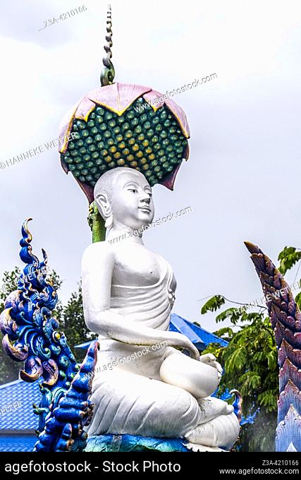 White monk statue at the Blue Temple (Wat Rong Suea Ten or Temple of the Dancing Tiger) in Chiang Rai, Thailand, Asia. Blue is symbolically associated with...