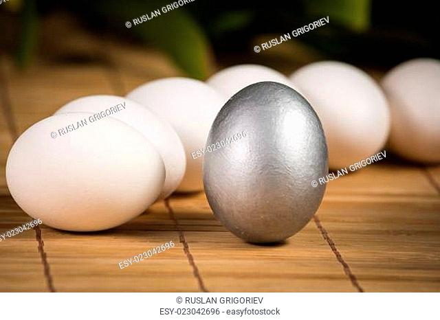 Silver Easter eggs with craquelures in wicker basket