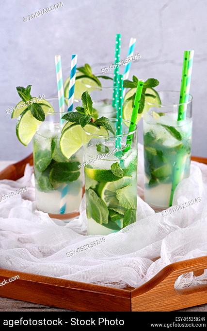 Refreshing infused water with cucumber, mint and lime. Summer drink cocktail lemonade. Healthy drink and detox concept