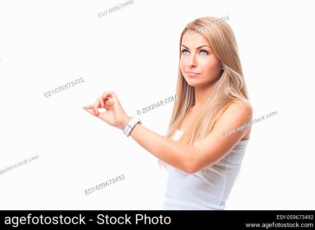 Beautiful blond young woman looking at wrist watch. Isolated on white background. Copy space
