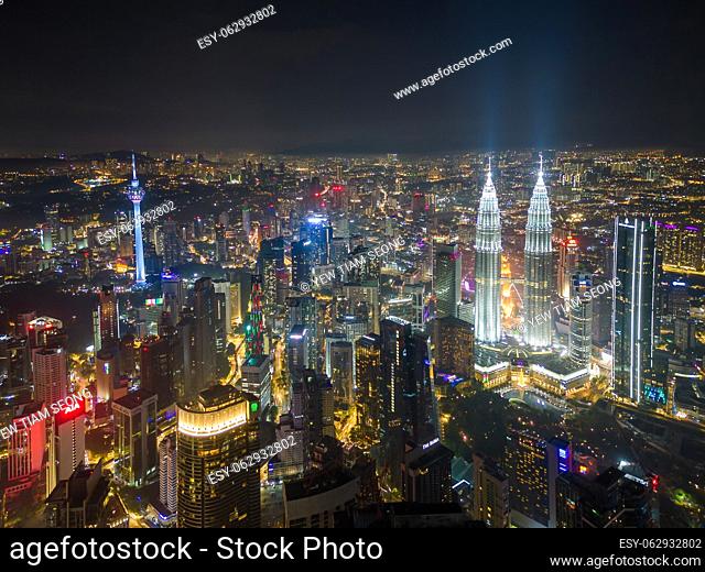 Bukit Bintang, Kuala Lumpur, Malaysia - Nov 29 2022: The Petronas Twin Towers stand tall, illuminated against the dark sky