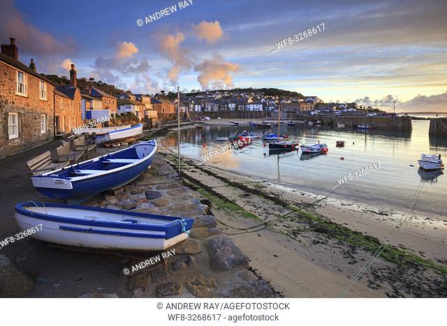 Boats at the Cornish fishing village of Mousehole, captured shortly after sunrise, using a wide angle zoom lens at it's widest setting, in late April