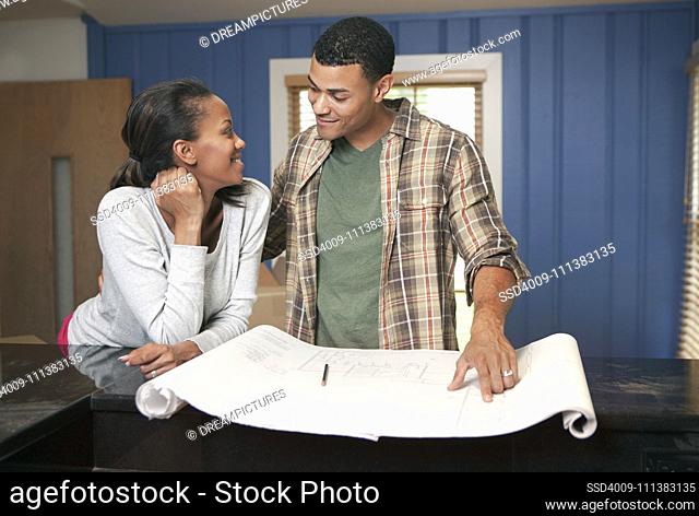 Couple looking at blueprints together