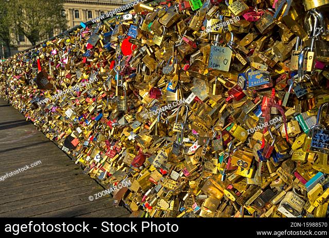 Too many locks of love on the railing of a bridge over the Seine in Paris