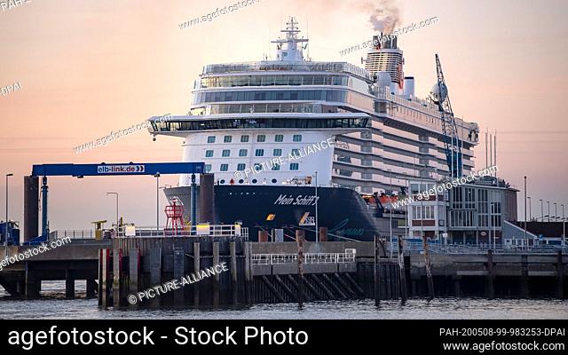 08 May 2020, Lower Saxony, Cuxhaven: The cruise liner ""Mein Schiff 3"" is moored in the harbour in the early morning. The crew members of the cruise liner...