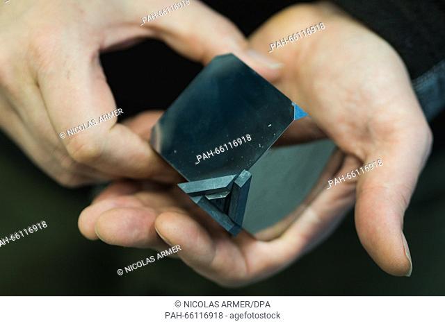 Geoscientist Daniel Frost of the Bavarian Research Institute of.Experimental Geochemistry and Geophysics (BGI) at the University of Bayreuth holds a cube made...