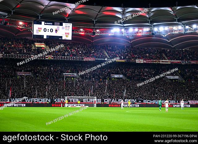 20 December 2023, Baden-Württemberg, Stuttgart: Soccer: Bundesliga, VfB Stuttgart - FC Augsburg, Matchday 16, MHPArena. VfB Stuttgart fans hold up a poster...