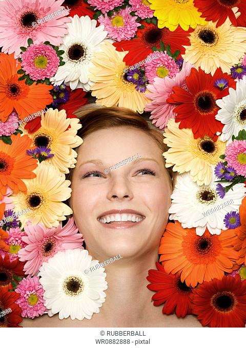 Close-up of a young woman lying on flowers