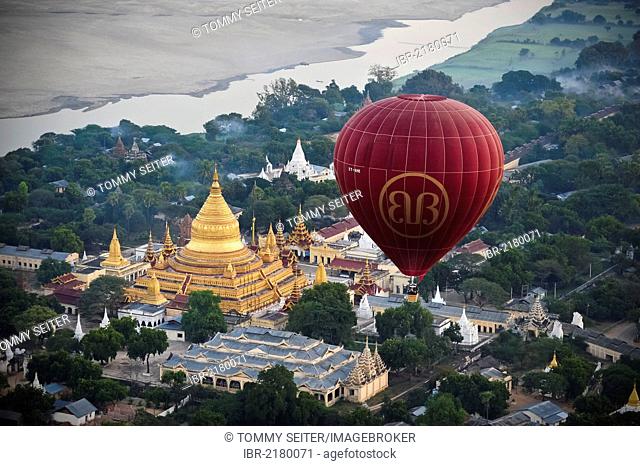 Hot air balloon at dawn over the Shwezigon Pagoda in Bagan, Myanmar, Burma, Southeast Asia, Asia