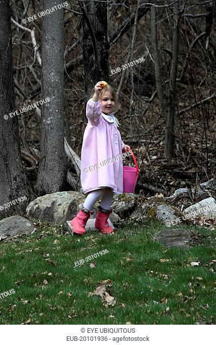 Young girl Sarah Bleau taking part in Easter egg hunt in Keene New Hampshire