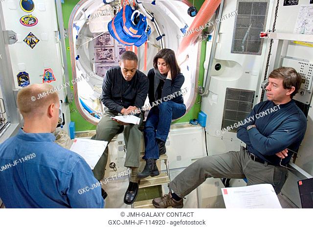 NASA astronauts Michael Barratt (right), Nicole Stott, Alvin Drew and Tim Kopra (back to camera), all STS-133 mission specialists