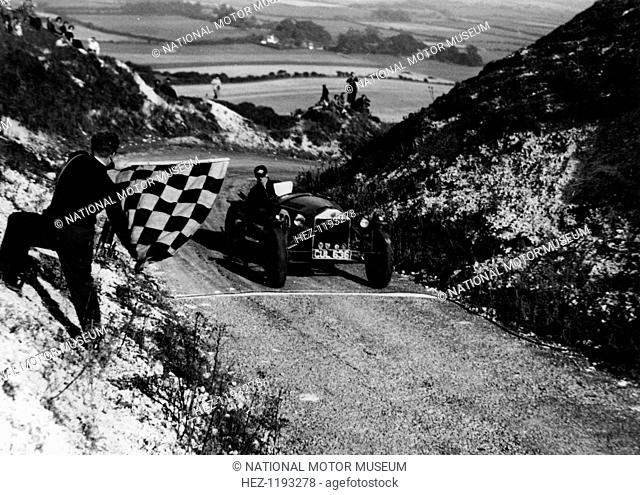 Lancia Lambda passing the chequered flag, Firle Hill Climb, Sussex, September 1951