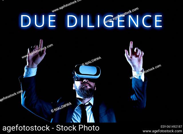 Text sign showing Due Diligence, Word for Comprehensive Appraisal Voluntary Investigation Audit Man Wearing Virtual Reality Simulator Raising Hand During...