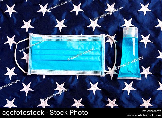 Medical protective disposable face mask for cover mouth on blue America star flag background, studio shot, Safety healthcare medical prevent coronavirus or...