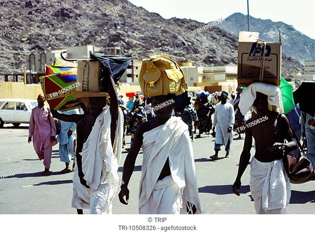 Saudi Arabia Makkah Hajj Pilgrims Dressed in White Carrying Boxes on their Heads