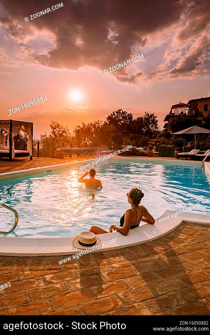 Luxury country house with swimming pool in Italy. Pool and old farm house during sunset central Italy. Couple on Vacation at luxury villa in Italy