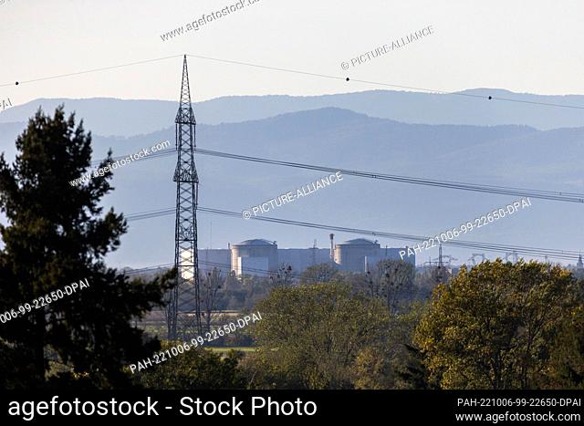 PRODUCTION - 05 October 2022, Baden-Württemberg, Heitersheim: The French nuclear power plant Fessenheim stands in the evening light while the French Vosges...
