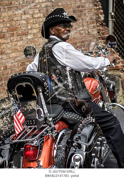 Senior African American man riding motorcycle