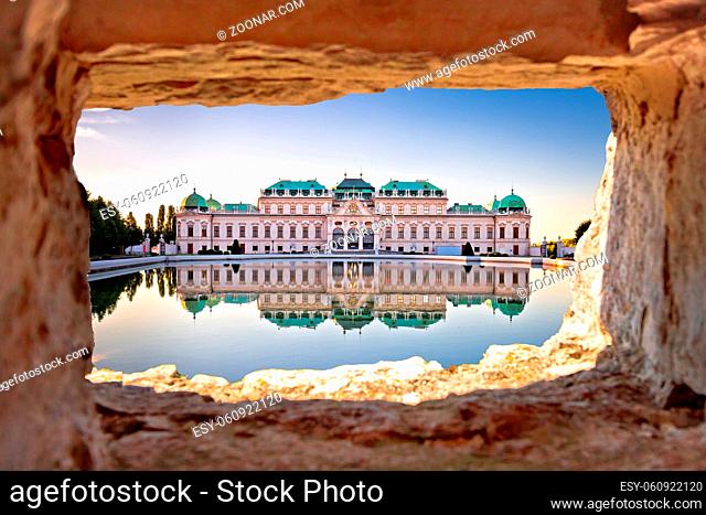 Belvedere in Vienna water reflection view through stone window at sunset, landmark of capital of Austria
