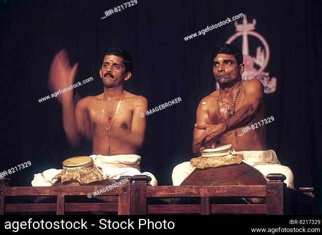 Playing the Mizhavu, a copper drum covered with animal skin during Koodiyattam performance in Kerala Kalamandalam, Kerala, India, Asia