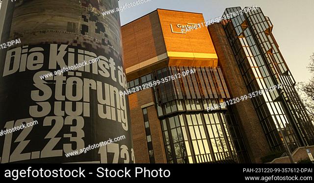 PRODUCTION - 19 December 2023, Bavaria, Munich: An advertising pillar with a poster reading ""Die Kunststörung 12.23."" stands in front of the Gasteig building...