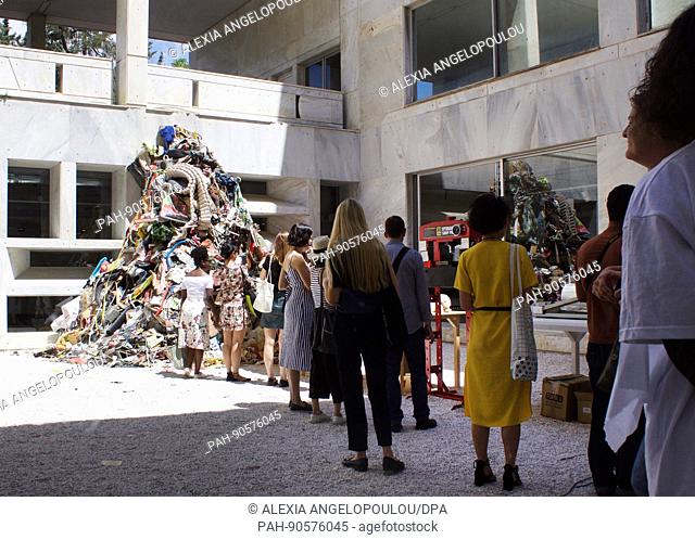 Visitors contemplate the piece -Materialization- by German artist Daniel Knorr at the Athens Conservatoire during the art event documenta 14 in Athens, Greece