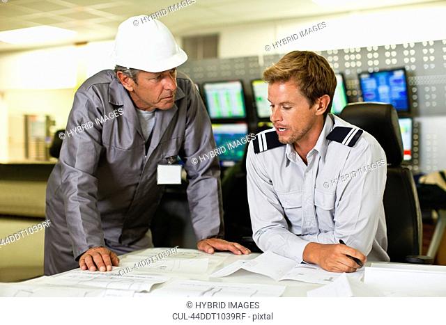 Men working in security control room