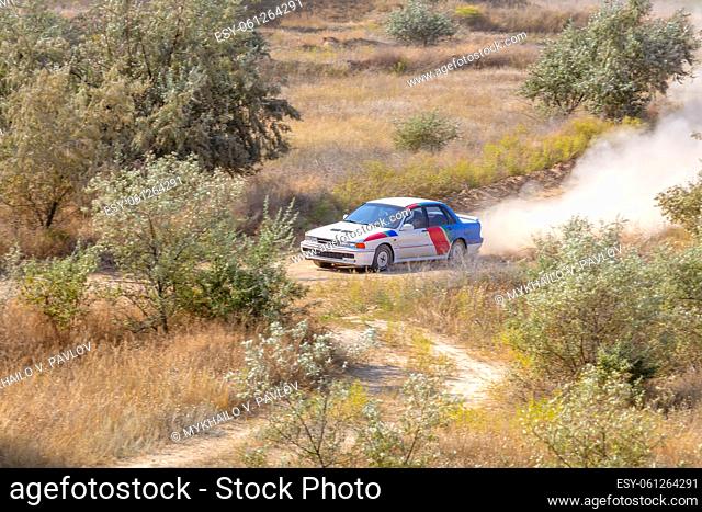 Sunny summer day. Dusty rally track. Sports car does a lot of dust in turn 04