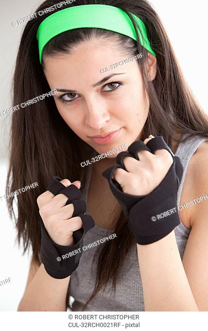 Defensive woman in boxing gloves