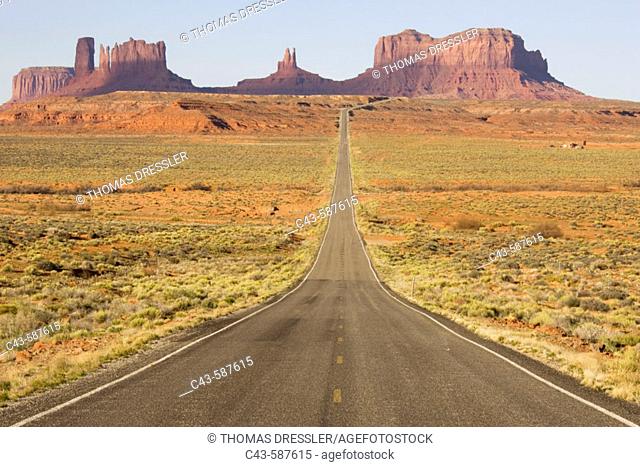 One of the most famous images of the Monument Valley is the long straight road (US 163) leading across flat desert towards sandstone buttes and pinnacles of...