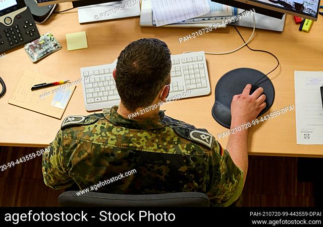 19 July 2021, Berlin: A first sergeant and employee in the operations centre of the Bundeswehr in the ""Kommando Territoriale Aufgaben"" works on his computer