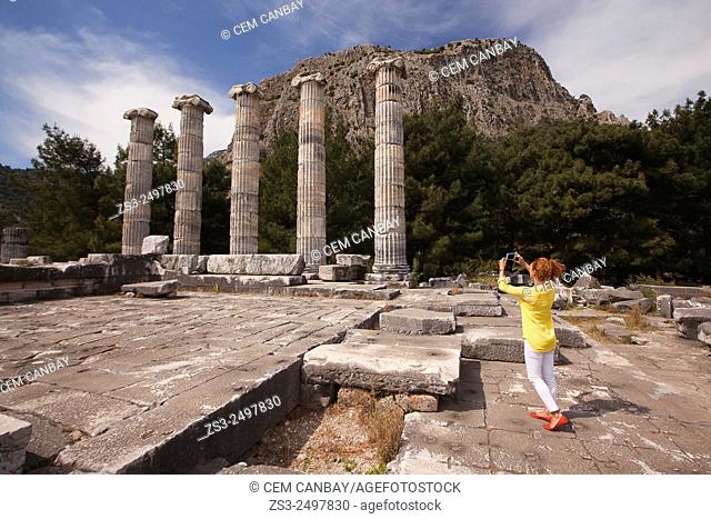 Tourist taking photos at the Temple of Athena, the ancient city of Priene, Aydin Province, Turkey, Europe