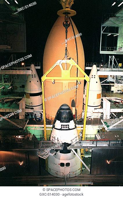 11/05/1999 -- Personnel work near the nose of Space Shuttle Discovery as it stands in a vertical position in the Vehicle Assembly Building