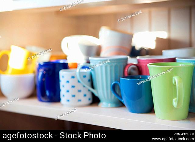 Many mugs on shelf are clean and dry